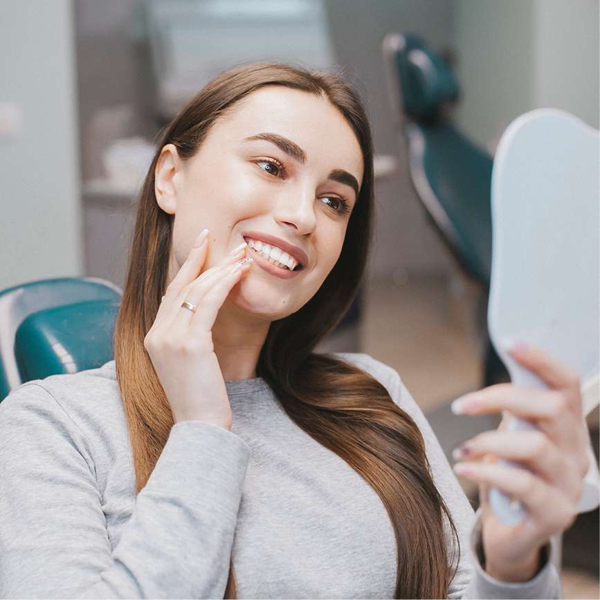 Young woman admiring her white teeth