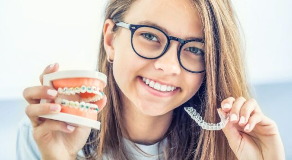 A satisfied patient at Friedman Dental Group, showcasing a straight, confident smile achieved with expert Invisalign treatment in Coral Springs.