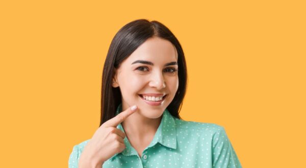 A satisfied patient at Friedman Dental Group, showcasing a radiant, healthy smile achieved with thorough teeth cleaning in Miami.