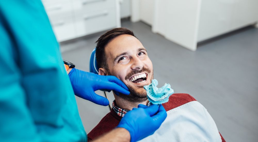 Dentist and satisfied patient post-dental implant placement at Friedman Dental Group, a trusted provider for Dental Implants in Miami