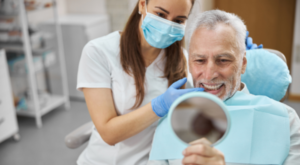 Dentist and satisfied patient post-dental implant placement at Friedman Dental Group, a trusted provider for Dental Implants in Coral Springs