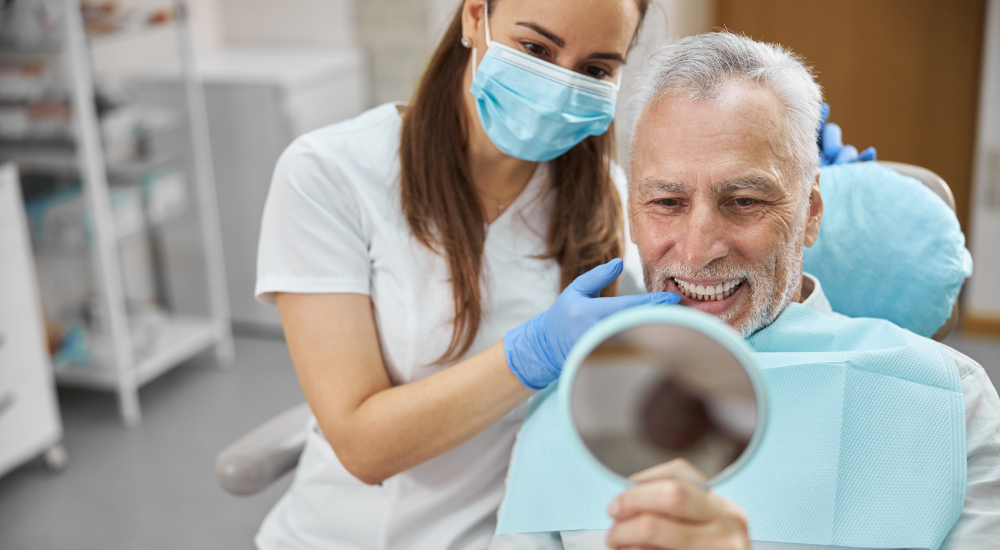 Dentist and satisfied patient post-dental implant placement at Friedman Dental Group, a trusted provider for Dental Implants in Coral Springs