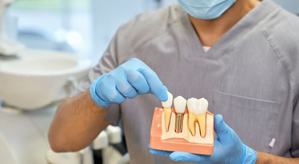 Dentist and satisfied patient post-dental implant placement at Friedman Dental Group, a trusted provider for Dental Implants near Boca Raton.